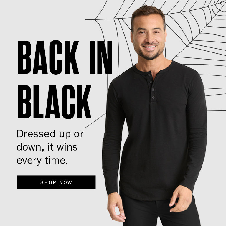 Man wearing a black long-sleeve shirt with promotional text on a light gray background