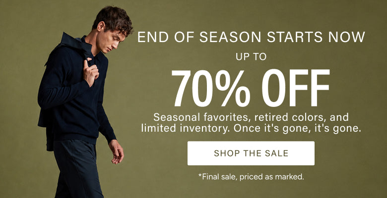 A promotional sale banner featuring a man in a dark navy hoodie and jeans walking against a muted olive background, with large text reading 'END OF SEASON STARTS NOW', 'UP TO 70% OFF', and a 'SHOP THE SALE' button.
