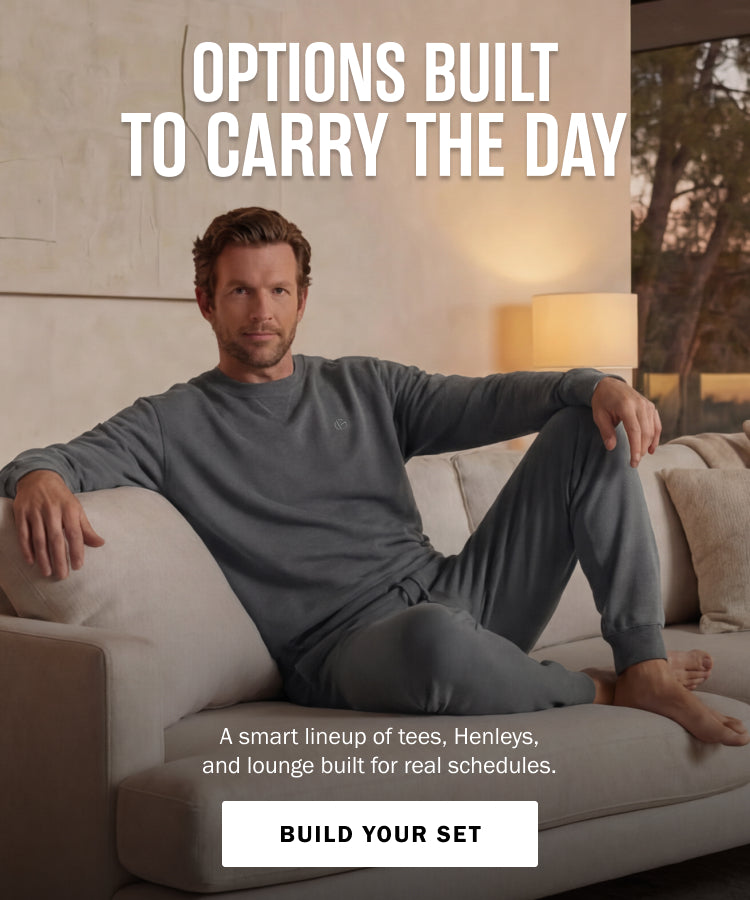 Man sitting on a couch wearing a gray outfit with promotional text overlay.